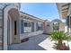 A single-story home with gray stone accents, blue shutters, and gated entrance at 2080 Orchard Mist St, Las Vegas, NV 89135