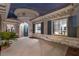 Home with a unique turret-style entrance, gray stone accents, and blue shutters at 2080 Orchard Mist St, Las Vegas, NV 89135