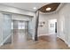 Welcoming home foyer with hardwood flooring, curved ceiling design, and glass sliding doors to the office at 2080 Orchard Mist St, Las Vegas, NV 89135