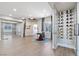 Hallway with wine cellar, art display, and view to an enclosed office and other parts of the home at 2080 Orchard Mist St, Las Vegas, NV 89135