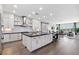 Open kitchen with a large center island, modern white cabinets, and views into the living area at 2080 Orchard Mist St, Las Vegas, NV 89135