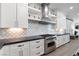 Kitchen with custom backsplash, modern white cabinets, stainless steel oven and a gourmet range at 2080 Orchard Mist St, Las Vegas, NV 89135