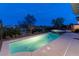 Illuminated backyard pool and spa with paved patio and decorative landscaping for evening enjoyment at 2080 Orchard Mist St, Las Vegas, NV 89135