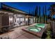 Backyard pool and spa area with patio, landscaping, and lighting offers a serene and luxurious outdoor space at 2080 Orchard Mist St, Las Vegas, NV 89135