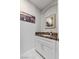 Tastefully decorated powder room with a granite countertop vanity and decorative mirror and painting at 2080 Orchard Mist St, Las Vegas, NV 89135