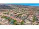 Picturesque aerial view of a community with homes, desert landscaping, and stunning mountain views at 2764 Leys Burnett Ave, Henderson, NV 89044