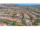 An aerial view highlighting a vast neighborhood with various homes, desert landscaping, and mountain views at 2764 Leys Burnett Ave, Henderson, NV 89044