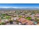 Sweeping aerial view showcasing a vibrant community surrounded by mountain views and lush landscaping at 2764 Leys Burnett Ave, Henderson, NV 89044