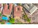 Stunning aerial view of a home featuring a terracotta roof, desert landscaping, and a sparkling blue pool at 2764 Leys Burnett Ave, Henderson, NV 89044