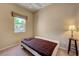 Simple bedroom with a single bed, side table, and window providing natural light at 2764 Leys Burnett Ave, Henderson, NV 89044