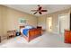 Bright bedroom with a ceiling fan, carpeted floor, and wood furniture at 2764 Leys Burnett Ave, Henderson, NV 89044