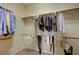Walk-in closet with clothes hanging on rods and shelves at 2764 Leys Burnett Ave, Henderson, NV 89044