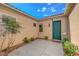 Private front courtyard featuring a secure door, lush landscaping, and neutral stucco at 2764 Leys Burnett Ave, Henderson, NV 89044