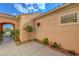 Inviting private courtyard featuring a secure entry, charming landscaping, and stucco walls at 2764 Leys Burnett Ave, Henderson, NV 89044