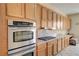 Close-up of stainless steel appliances, stove, and wood cabinets in kitchen at 2764 Leys Burnett Ave, Henderson, NV 89044