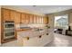Spacious kitchen with an island, double oven, and wood cabinets at 2764 Leys Burnett Ave, Henderson, NV 89044