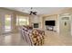 Cozy living room with a fireplace, neutral walls, and a door leading to the outside at 2764 Leys Burnett Ave, Henderson, NV 89044