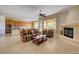 Open-concept living room with fireplace, ceiling fan, and views of the kitchen at 2764 Leys Burnett Ave, Henderson, NV 89044