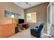 Home office area with desk, dresser, and a blue recliner facing a bright window at 2764 Leys Burnett Ave, Henderson, NV 89044