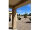 Backyard patio with desert landscaping and a view of mature trees at 3029 Frigate Way, North Las Vegas, NV 89084