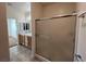 Neutral bathroom with double sink vanity, large mirror, and sliding glass shower doors at 3029 Frigate Way, North Las Vegas, NV 89084