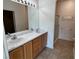 Bathroom featuring a double sink vanity, large mirror with vanity lighting, and a glass-enclosed shower at 3029 Frigate Way, North Las Vegas, NV 89084