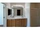 Bathroom featuring a double sink vanity, large mirror with vanity lighting, and a shower at 3029 Frigate Way, North Las Vegas, NV 89084