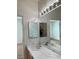 Neutral bathroom with double sink vanity, large mirror, and updated lighting at 3029 Frigate Way, North Las Vegas, NV 89084