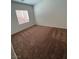 Cozy bedroom with neutral carpet and ample natural light from a large window at 3029 Frigate Way, North Las Vegas, NV 89084