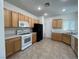 The eat-in kitchen includes a black refrigerator, a white oven and updated lighting at 3029 Frigate Way, North Las Vegas, NV 89084