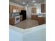 Bright kitchen featuring wood cabinets, white appliances, and plenty of counter space at 3029 Frigate Way, North Las Vegas, NV 89084