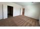 Spacious primary bedroom with neutral carpet and adjoining bathroom with tile flooring at 3029 Frigate Way, North Las Vegas, NV 89084