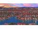 Stunning aerial view of a lakeside community with the city skyline and a colorful sunset in the background at 3080 Yankee Clipper Dr, Las Vegas, NV 89117
