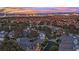Scenic evening aerial view of a residential neighborhood showcasing a vibrant cityscape and colorful sky at 3080 Yankee Clipper Dr, Las Vegas, NV 89117