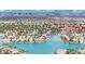 A beautiful aerial view of a waterfront community showing the canal and single-Gathering homes with city skyline beyond at 3080 Yankee Clipper Dr, Las Vegas, NV 89117