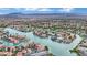 Expansive aerial view showcasing a waterfront community nestled among canals with a mountain range in the background at 3080 Yankee Clipper Dr, Las Vegas, NV 89117