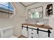 Modern bathroom with stylish vanity, vessel sink, barn-door style cabinet doors, and a custom mirror at 3080 Yankee Clipper Dr, Las Vegas, NV 89117