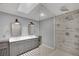 Modern bathroom with a walk-in shower, double vanity with gray cabinets, and unique patterned tile floors at 3080 Yankee Clipper Dr, Las Vegas, NV 89117