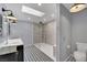 Modern bathroom with a walk-in shower, double vanity with marble countertop, and unique patterned floors at 3080 Yankee Clipper Dr, Las Vegas, NV 89117