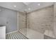 Modern bathroom featuring a spacious glass shower with decorative tile and patterned floor at 3080 Yankee Clipper Dr, Las Vegas, NV 89117