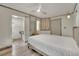 Bedroom with wood-look floors, gray walls, a ceiling fan, white bedding, and a view into the bathroom at 3080 Yankee Clipper Dr, Las Vegas, NV 89117
