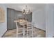 Cozy dining area with gray cabinets, a decorative chandelier, and a table with seating for four at 3080 Yankee Clipper Dr, Las Vegas, NV 89117