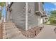 Two-story exterior with gray siding and landscaping with stairs that lead to the entry at 3080 Yankee Clipper Dr, Las Vegas, NV 89117