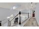 Bright hallway with skylights, hardwood floors, and staircase with white railing at 3080 Yankee Clipper Dr, Las Vegas, NV 89117