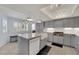 Charming kitchen features grey cabinets, marble counters, and a large farmhouse sink at 3080 Yankee Clipper Dr, Las Vegas, NV 89117
