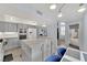 Open kitchen with a large island, white appliances, and a view of the staircase at 3080 Yankee Clipper Dr, Las Vegas, NV 89117