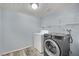 Bright laundry room with a light gray, front load washing machine, and a white top load dryer at 3080 Yankee Clipper Dr, Las Vegas, NV 89117
