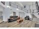 Spacious living room with high ceilings, a staircase, modern furnishings, and lots of natural light at 3080 Yankee Clipper Dr, Las Vegas, NV 89117