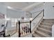 Elegant staircase featuring decorative tilework, a wooden railing, and an open view to the living area below at 3080 Yankee Clipper Dr, Las Vegas, NV 89117