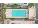 Aerial view of a community pool with lounge chairs, manicured bushes, and nearby houses at 3080 Yankee Clipper Dr, Las Vegas, NV 89117